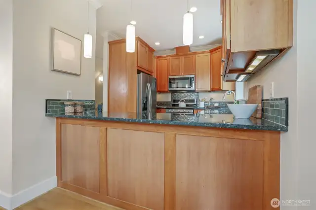 Serving/breakfast bar with pendant lighting.