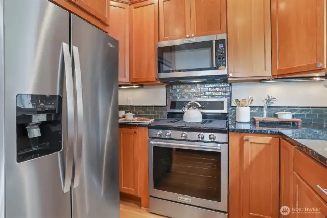 Desirable gas cooking and newer stainless steel Kitchen Aid appliances.