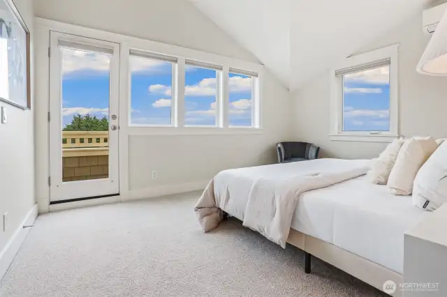 West facing primary suite with vaulted ceilings, wall of windows, and access to relaxing view balcony.