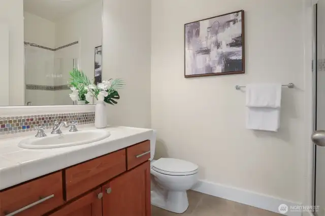 Convenient private ceramic tile bath accessed though bedroom.