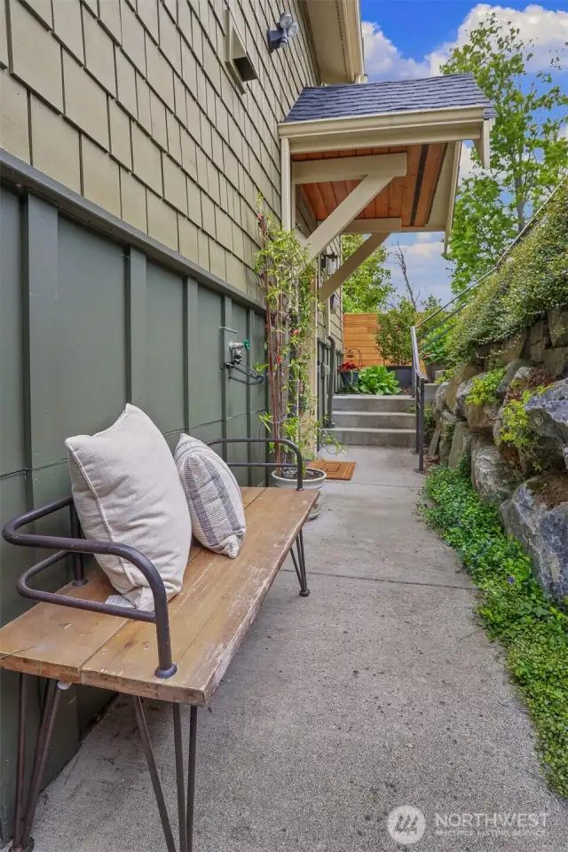 Covered main entry has rockery's that add greenery & privacy.