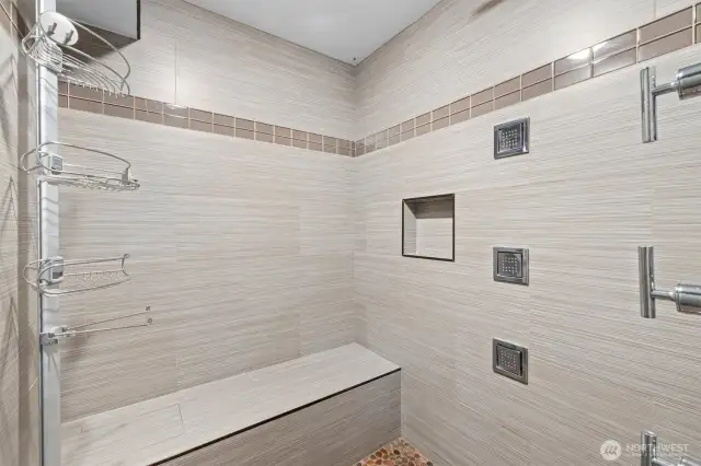 Lower shower is big with bench.