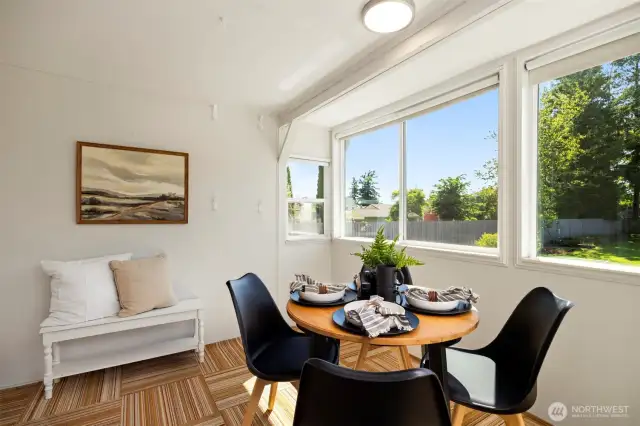 Bathed in natural light, the dining room overlooks a quiet backyard retreat.