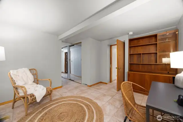 Basement "bedroom" or office space with half bathroom.