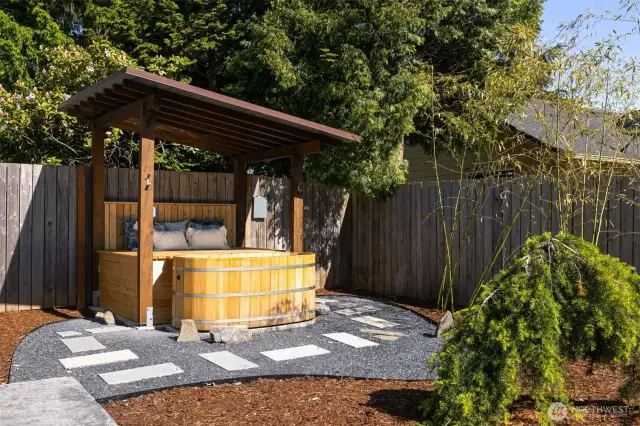 A custom-built cabana with a hot tub overlooks the backyard oasis—designed for peak relaxation.