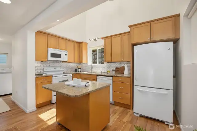 Very nice kitchen with granite counters and wood cabinets. The washer and dryer and full bathroom is to the left.