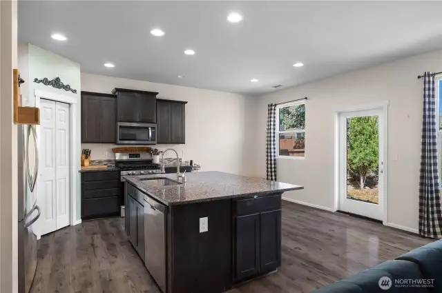 Well lit with multiple canned lights and natural lighting formt he sliding glass door and windows.
