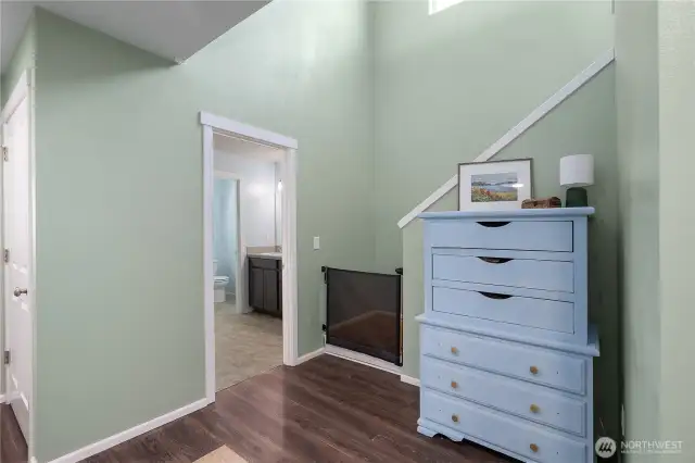 Entry to Full size bathroom on 2nd floor. Also showing the staircase to the 3rd floor loft/game room.