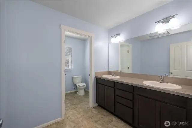 Full bath with double sinks and private bathtub/shower combo behind 2nd door.