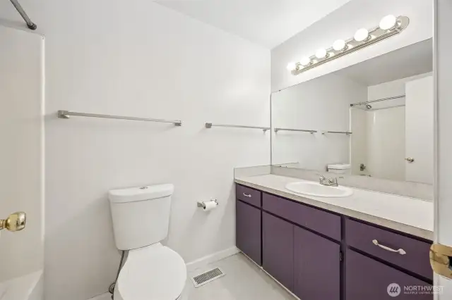Hall bath has a shower//tub combo is shared by the two bedrooms.