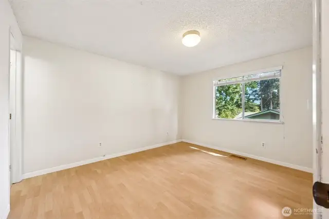 Primary suite has laminate flooring and an en suite bath.