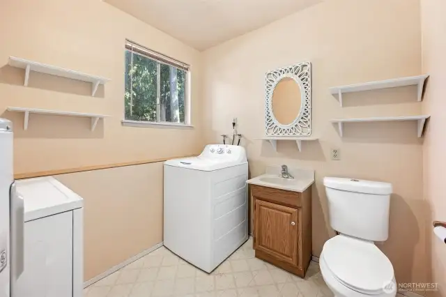 Utility room with a convenient half bath downstairs.