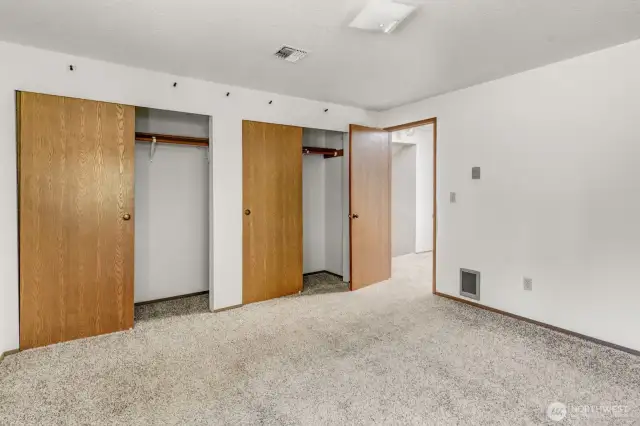 Another view of the Primary bedroom showing the dual closets.