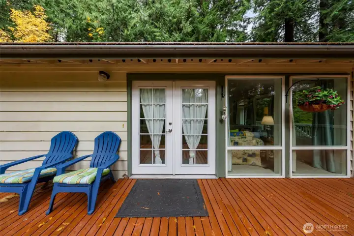 Main entry French doors with floor to ceiling windows in living room.