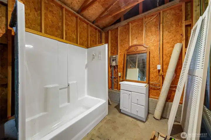 This bathroom is waiting to be completed in the corner of garage.