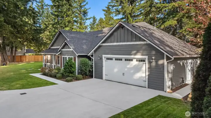 The extended driveway and spacious two-car garage provide ample parking and convenience.