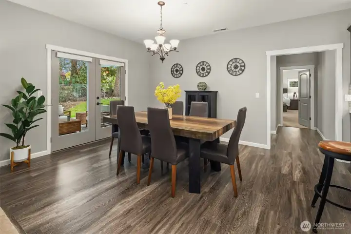 This elegant dining space offers the perfect backdrop for memorable meals — seamlessly extending to the outdoor patio for effortless entertaining year-round.