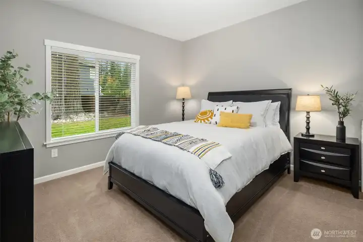 This comfortable bedroom offers peaceful views and a warm, restful ambiance — the perfect retreat for family or guests.