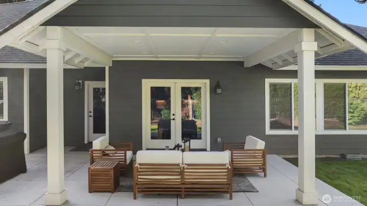 The covered patio offers year-round comfort — perfect for morning coffee, evening gatherings, or simply taking in the peaceful surroundings.