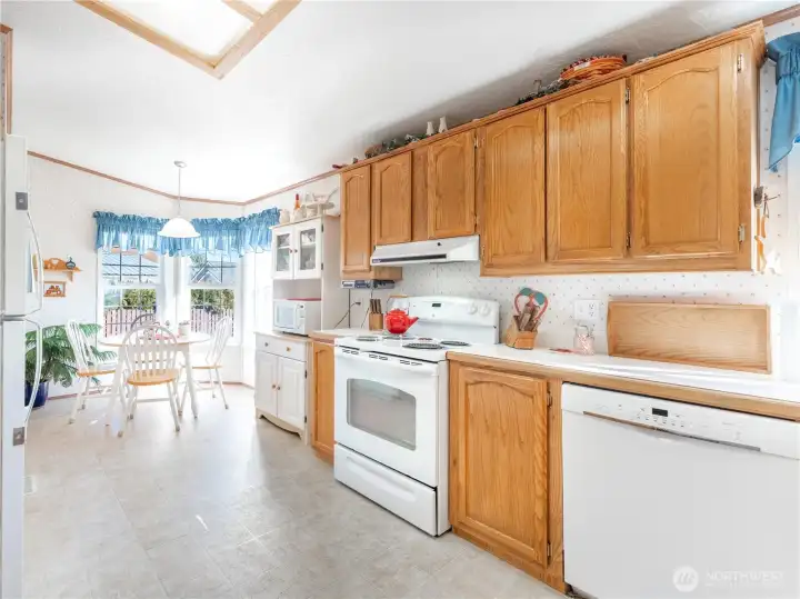 Bright kitchen featuring new appliances and ample cabinet space