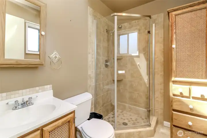 Primary bathroom features walk in shower and tons of storage space.