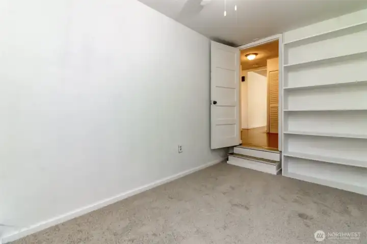 The third room features shelving adding extra storage of organization options.
