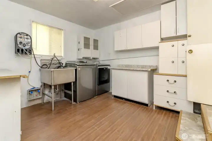 The utility room offers tons of storage along with a convenient sink, creating a practical space for laundry.
