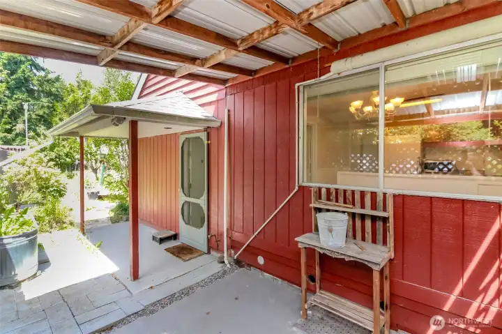 Step out onto a covered patio, ideal for outdoor meals and gatherings.