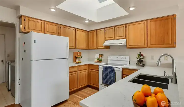 The kitchen is both stylish and functional with quartz countertops. All appliances stay as well!