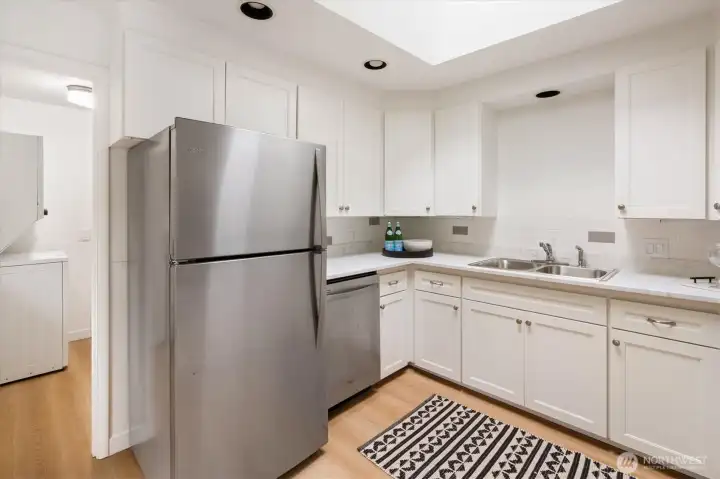 West home - 22511: This kitchen has space to prep and a skylight for extra light.