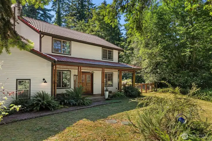 This gracious home enjoys a sylvan setting on the north end of Vashon Island -- the perfect base for exploring all Puget Sound has to offer.