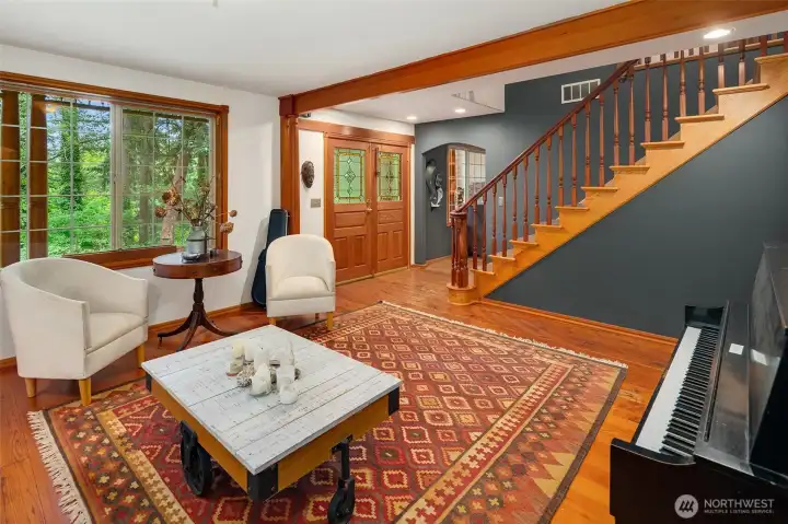 Looking back through the living room to front entry and stair to upper level,