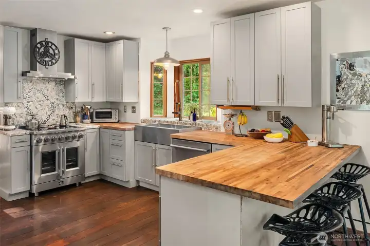 Recently renovated kitchen with lovely tile work, butcher block counters and stainless steel farm sink.