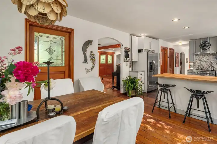 Looking back through the living room to front entry. Spaces flow elegantly one into another.