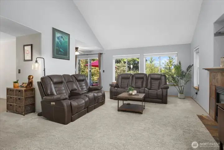 Large Living Room with plenty of windows, gas fireplace and vaulted ceilings. Flows to formal dining, kitchen and back patio.
