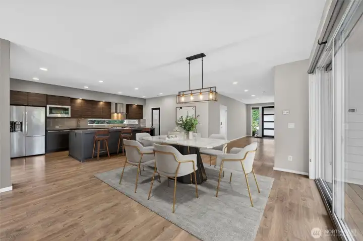 Virtually staged. Seamless connection between kitchen and dining room.