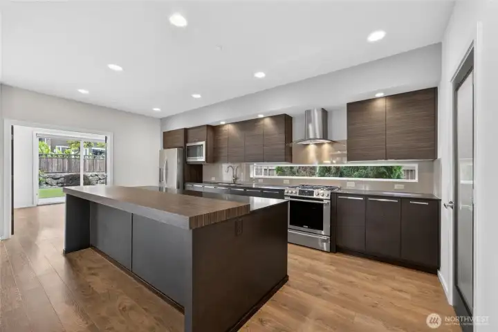 Beautifully updated kitchen at the heart of the home. An expansive center island offers a generous workspace.