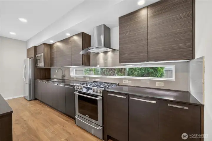 Quartz countertops provide style and durability. Stainless steel appliances complement the modern design.