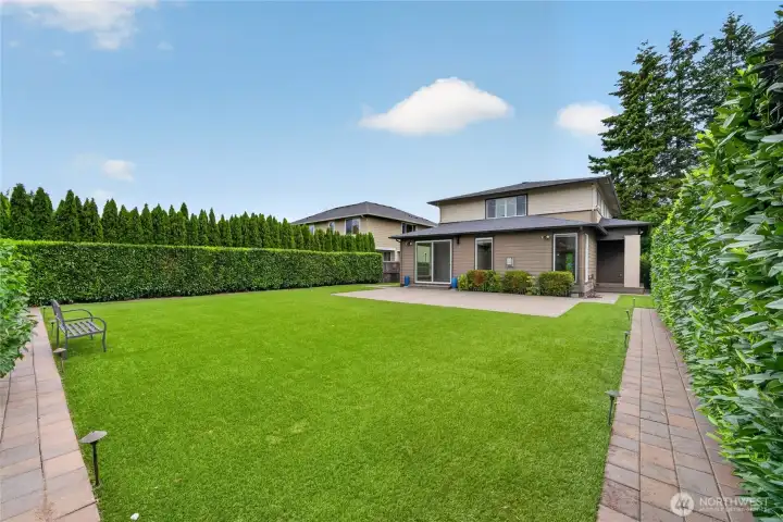 Fully fenced yard offers privacy and peace of mind. Easy-maintenance artificial turf stays green year-round.