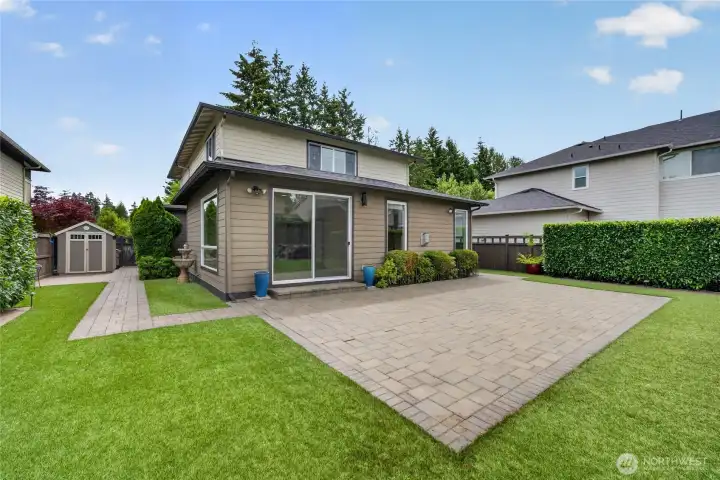 Rare flat backyard designed for enjoyment and recreation. Storage shed provides practical outdoor storage.