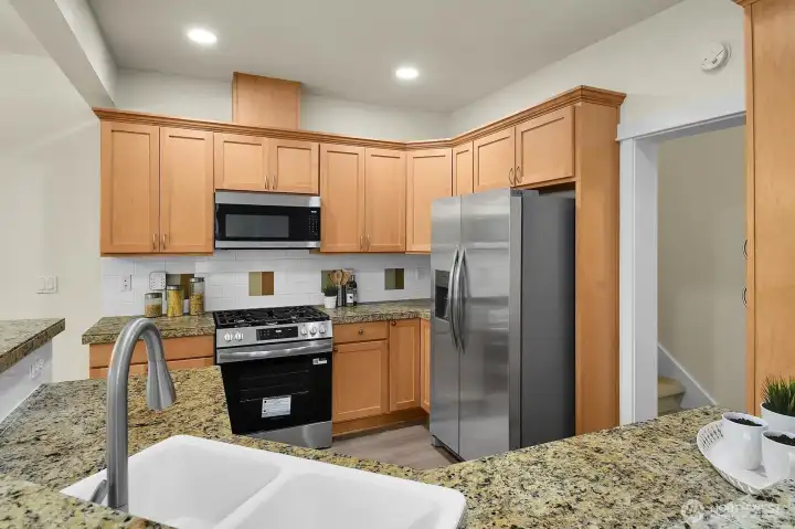 The open kitchen flows effortlessly into the living and dining areas, making gatherings and everyday living easy and enjoyable. The open kitchen flows effortlessly into the living and dining areas, making gatherings and everyday living easy and enjoyable.