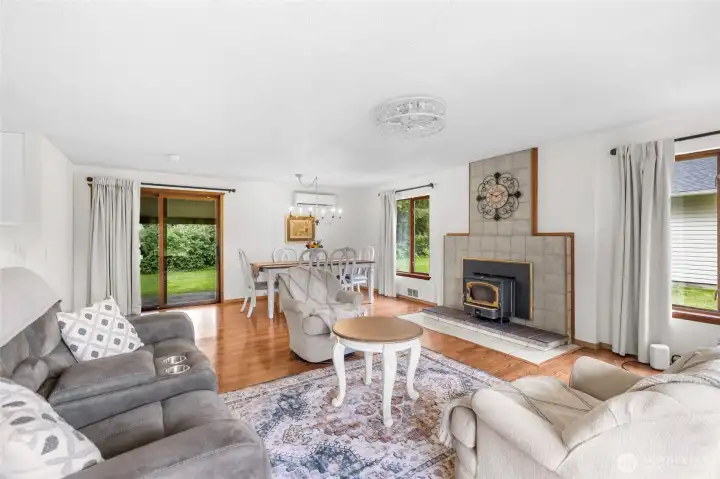 Open great room with woodstove insert and dining room. Open great room with woodstove insert and dining room.