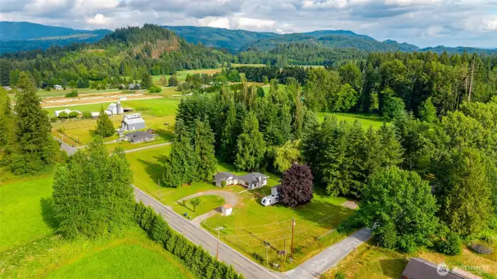 The 1.55 Acres is 308' of road frontage by 152" deep. The horse stall is behind the tall trees to the left of the house. The 1.55 Acres is 308' of road frontage by 152" deep. The horse stall is behind the tall trees to the left of the house.