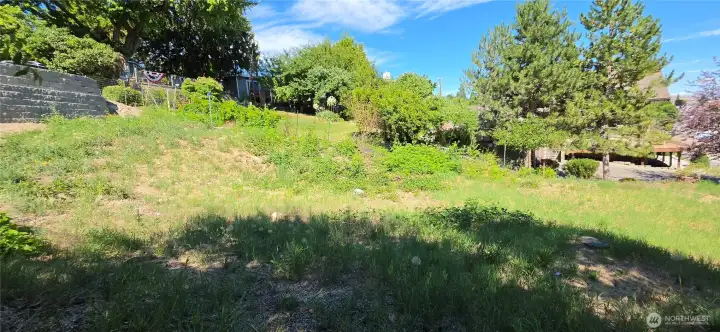 The upper part is steeper. That's the retaining wall for the neighboring's property. Their home is under construction.