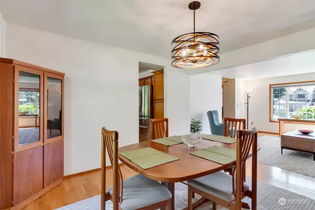 Formal dining room and living room feature beautiful hardwood floors.