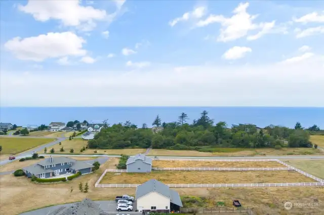 East side of property looking west to the Strait of Juan de Fuca.   Two fenced pastures and huge monitor style barn with concrete floor.  Located in NW Coupeville.