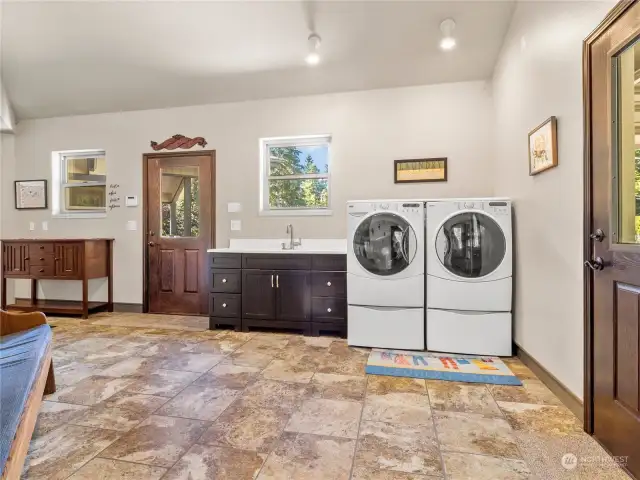 Mudroom/laundry room with doors to garage, front yard and backyard.