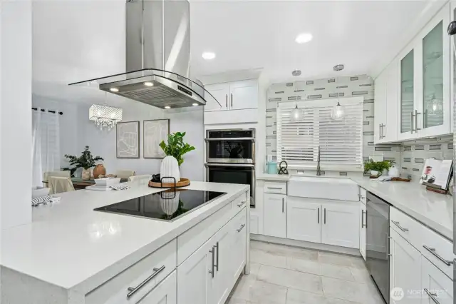 High end induction stove (with the induction pans).  Farmhouse sink & custom tiled backsplash