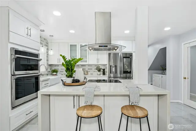 Waterfall Quartz counters and new beautiful cabinetry with undermount lighting