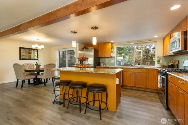 The has open kitchen features granite countertops and stainless steel appliances.